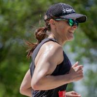 A participant smiles while running.